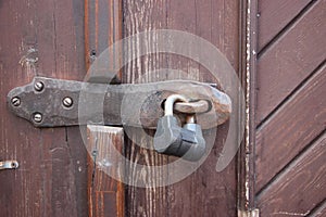 Hanging lock on brown ancient vintage door. locked old wooden door. Confidential information security concept