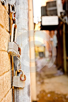 Hanging Locks and Chains Near Alley Between Buildings