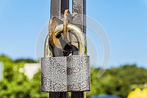 Hanging metal lock in the gates eyelets