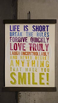 Hanging motivational word sign at the wall about life that say life is short brake the rules forgive quickly love truly laugh