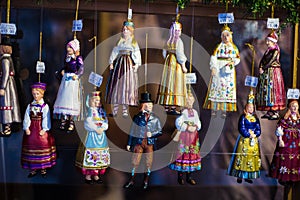 Hanging ornaments and figures in Estonian traditional folk costumes on sale at Tallinn Christmas market