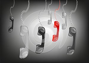 Hanging phone handsets in black background,