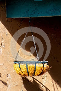 Hanging plant basket used to store fruits and vegetables to keep them ripe and to grow native plants on the porch of house