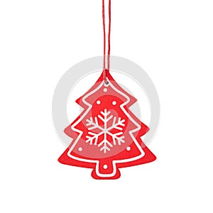 Hanging red wooden Christmas tree ornament with snowflake isolated on a white background.