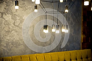 Hanging retro incandescent lamp on a background of wooden blinds.Creative loft style lamp with shining lightbulb.Hanging