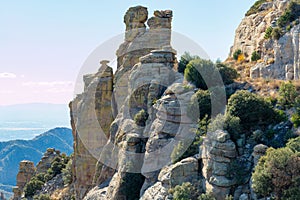 Hanging rock formations with the stones of arizona desert in late afternoon shade and sun with cliffs and mountains