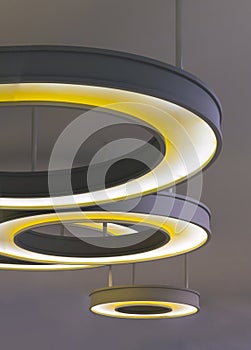 The hanging rounded ceiling mounted light fixtures with modern LED light bulb