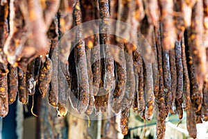 Hanging sausages in smokehouse for sale