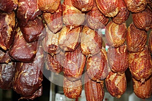 Hanging smoke-dried pork legs in retail market