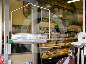 Hanging steel produce scale at the entrance of grocery store