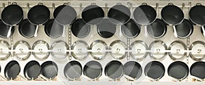 Hanging teflon pans and lids on wall