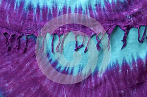 Hanging tie dye background with tassels on edge photo