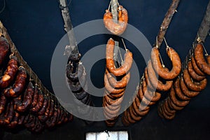 Hanging traditional saussages on smokehouse photo