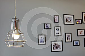 Hanging vintage style Lamp decor against gray wall with blur picture and frame background