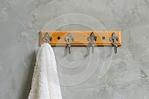 Hanging White Towel draped on Exposed Concrete Wall