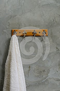 Hanging White Towel draped on Exposed Concrete Wall