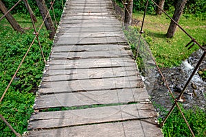 hanging wooden bridge in the forest