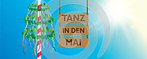 hanging wooden sign "tanz in den mai" maypole with colorful ribbons