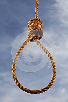 Hangman's noose with sky behind.