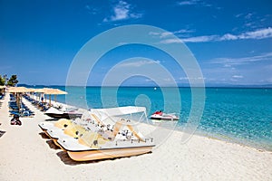 Hanioti beach with Colorful pedalos docked, Halkidiki, Greece.