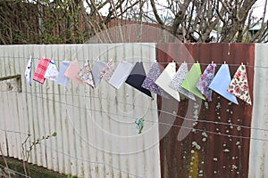 Hankies pegged onto fence wire