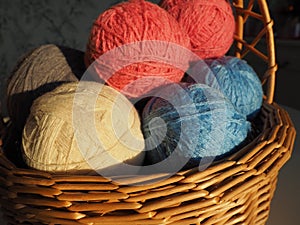 Hanks of woolen and acrylic threads. Knitting as a hobby. Accessories, balls of yarn and threads of white, pink and blue
