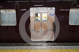 The Hankyu train or Osaka Express train stop at a subway station in Osaka. photo