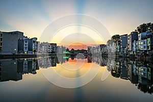 Hanoi cityscape at sunset. Resident buildings by Tien Bien lake, Gia Lam district