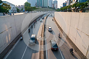 Hanoi traffic with vehicles running on Dai Co Viet crossing underpass tunnel exit