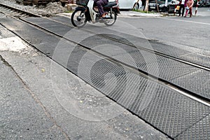 Hanoi train railroad crossing street with traffic on background