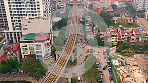 HANOI, VIETNAM - APRIL, 2020: Aerial drone view of the railroad overpass with station and cityscape of Hanoi near lake.