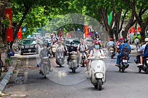 Hanoi, Vietnam Aug 29, 2022 : Motorbike riders on the busy roads, Heavy rush hour traffic in downtown Hanoi, Vietnam