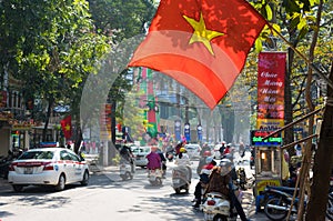 Hanoi, Vietnam - Jan 1, 2015: Traffic on Ba Trieu street in the first day of 2015. People in Vietnam often display flag in front o