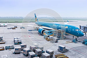 Vietnam Airlines aircraft loading air cargo containers before flight at Noi Bai international airport in Hanoi, Vietnam.