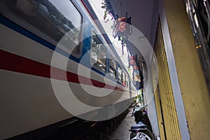 Hanoi, Vietnam - May 28, 2023: Train Street in Hanoi is a narrow, bustling lane with tracks. Close knit houses, adorned with