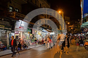 Night life of the street view in Hanoi Old Quarter, people can seen exploring and shopping around it.