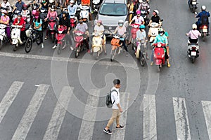 Hanoi, Vietnam - Oct 11, 2016: Aerial view of traffic on Dai La street at rush hour, with a boy crossing street