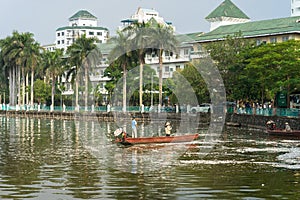 Hanoi, Vietnam - Oct 2, 2016: Garbage collector, environment workers take mass dead fishes out from West Lake