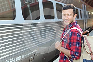 Hansdome commuter smiling while waiting for his train