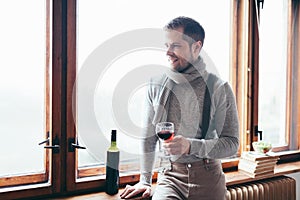 Hansome man enjoying a glass of red wine