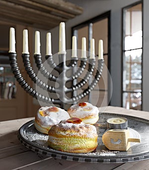 Hanukkah background with candles, donuts, spinning top