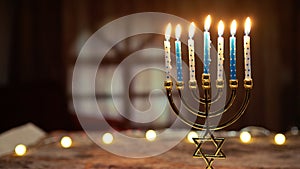 Hanukkah candlestick with book on table