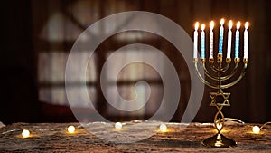 Hanukkah candlestick with book on table