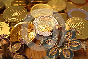 Hanukkah chocolate coins with star of David and menorah on back and silver dreidel with pomegranate