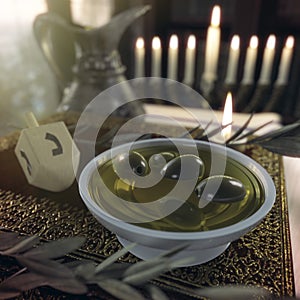 Hanukkah close up with candles, old books, spinning top