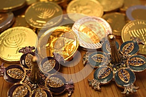 Hanukkah gelt chocolate coins with star of David on back and silver dreidel with pomegranate