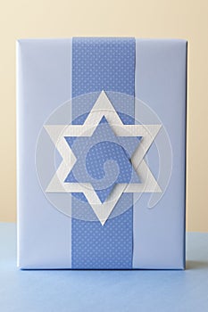 Hanukkah gift present with handmade Star of David decoration. Jewish holiday traditions paper crafts photo