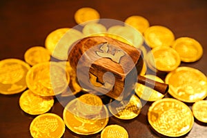 Hanukkah gold gelt coins and dreidel on a table