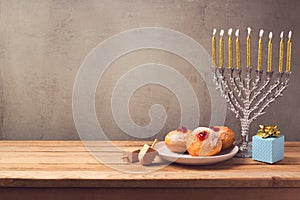 Hanukkah holiday sufganiyot and menorah on wooden table