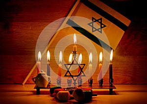 Hanukkah is a Jewish holiday. Burning Chanukah candlestick with candles. Chanukiah Menorah. dreidel, savivon. Flag of Israel